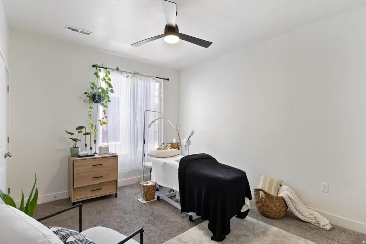 Recessed lighting, ceiling fan with integrated light, large window with curtain rod, and neutral wall paint