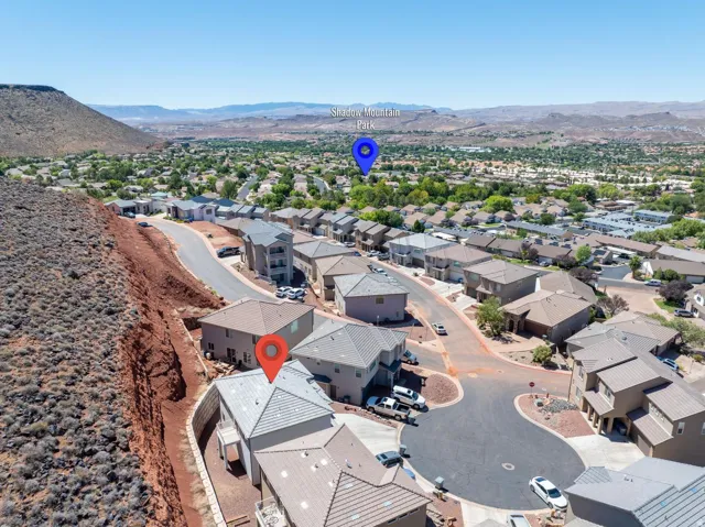 Residential neighborhood with cul-de-sac street design, surrounded by a natural desert landscape