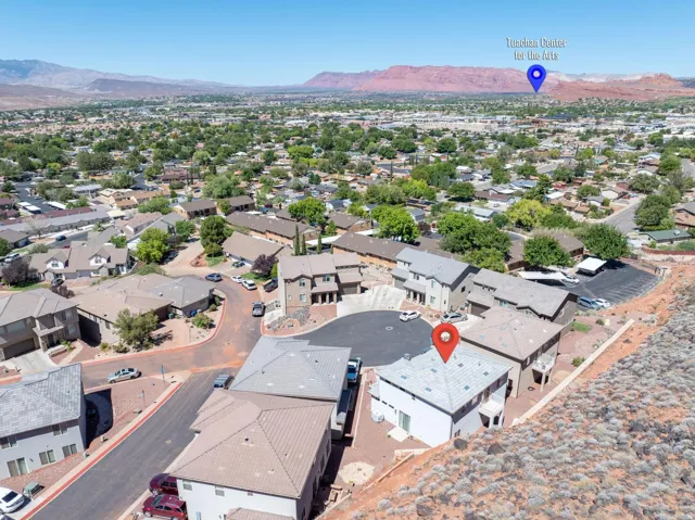 Aerial perspective of the neighborhood with surrounding homes and mountainous terrain