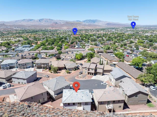 Residential neighborhood with varied rooflines and mountain backdrop