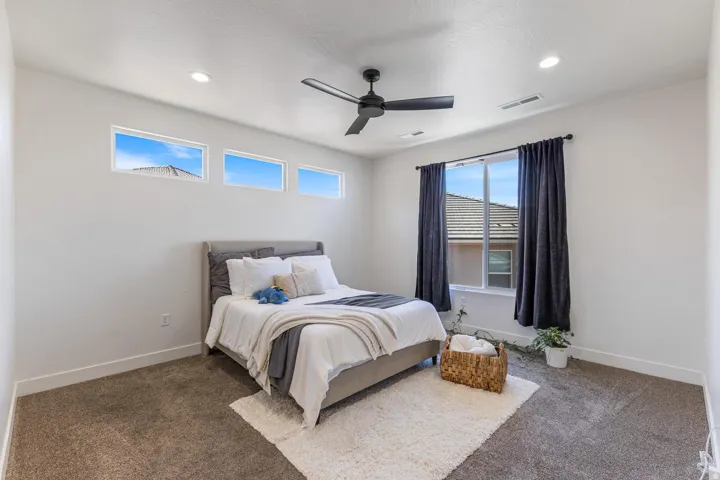 Recessed lighting, ceiling fan, and carpeted flooring