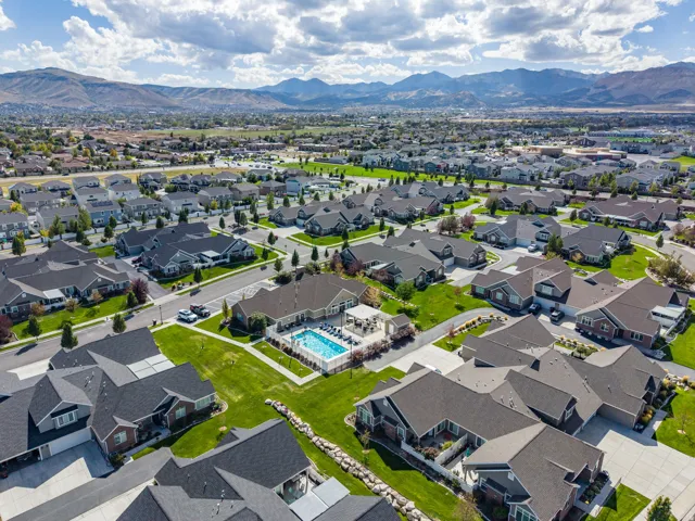 Expansive residential neighborhood with distant mountain ranges and a community pool