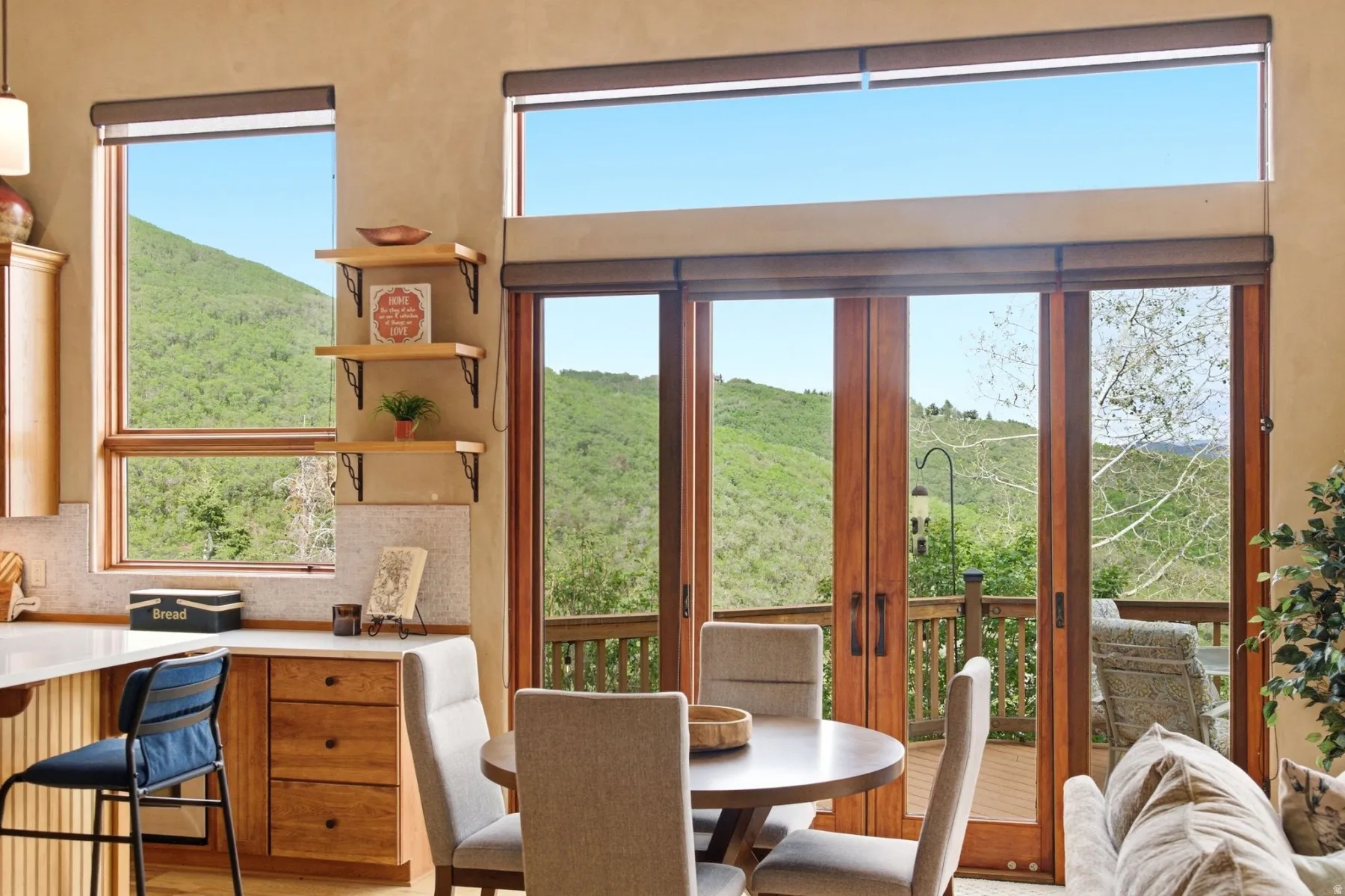 Wood-finish French doors leading to an exterior deck, complemented by an overhead transom window