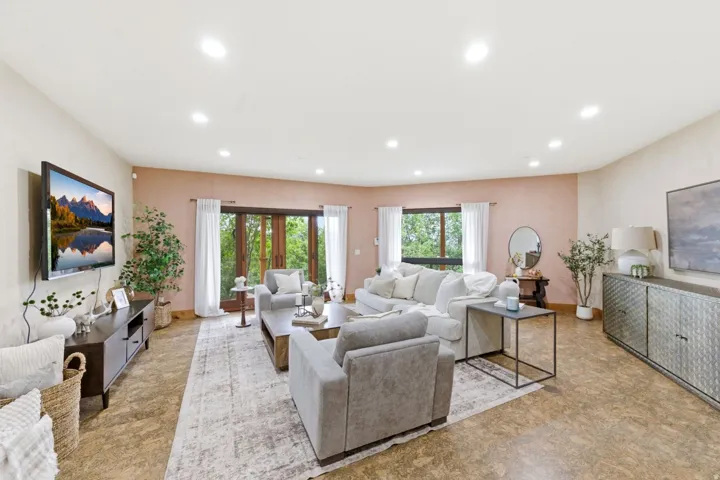 Recessed lighting, wood-finish flooring, and a sliding glass door