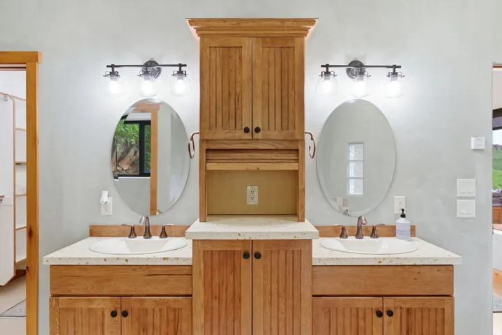 Dual vanity with white undermount sinks and light-toned countertops