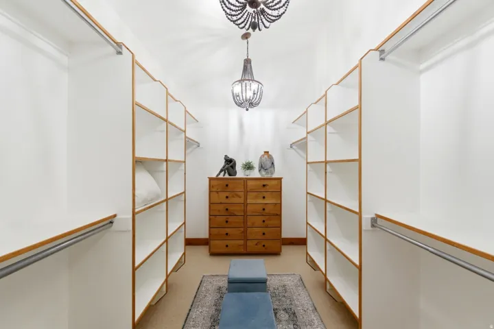 Custom closet system with extensive shelving and hanging rods
