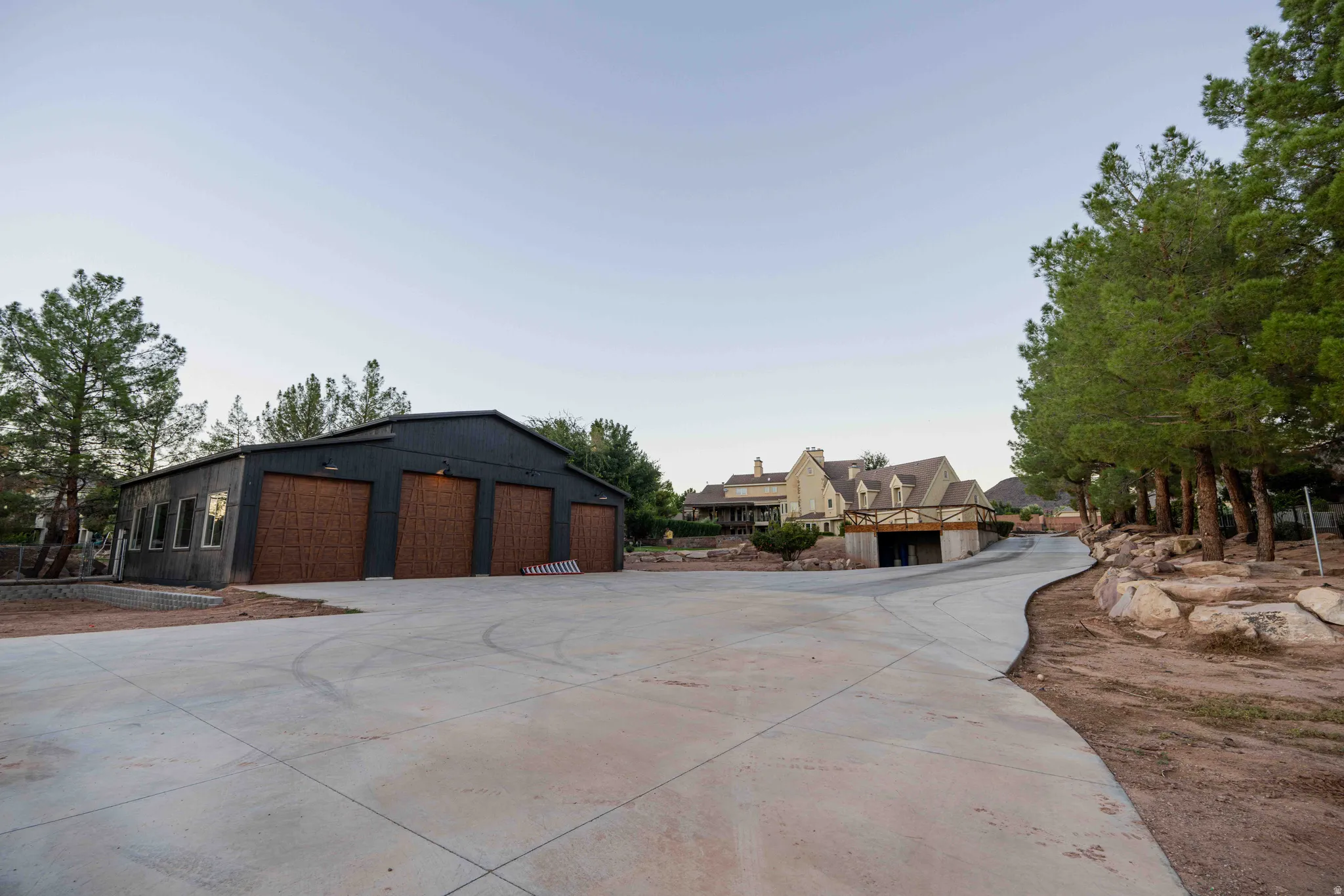 Four-bay garage with wood-finish doors and dark siding
