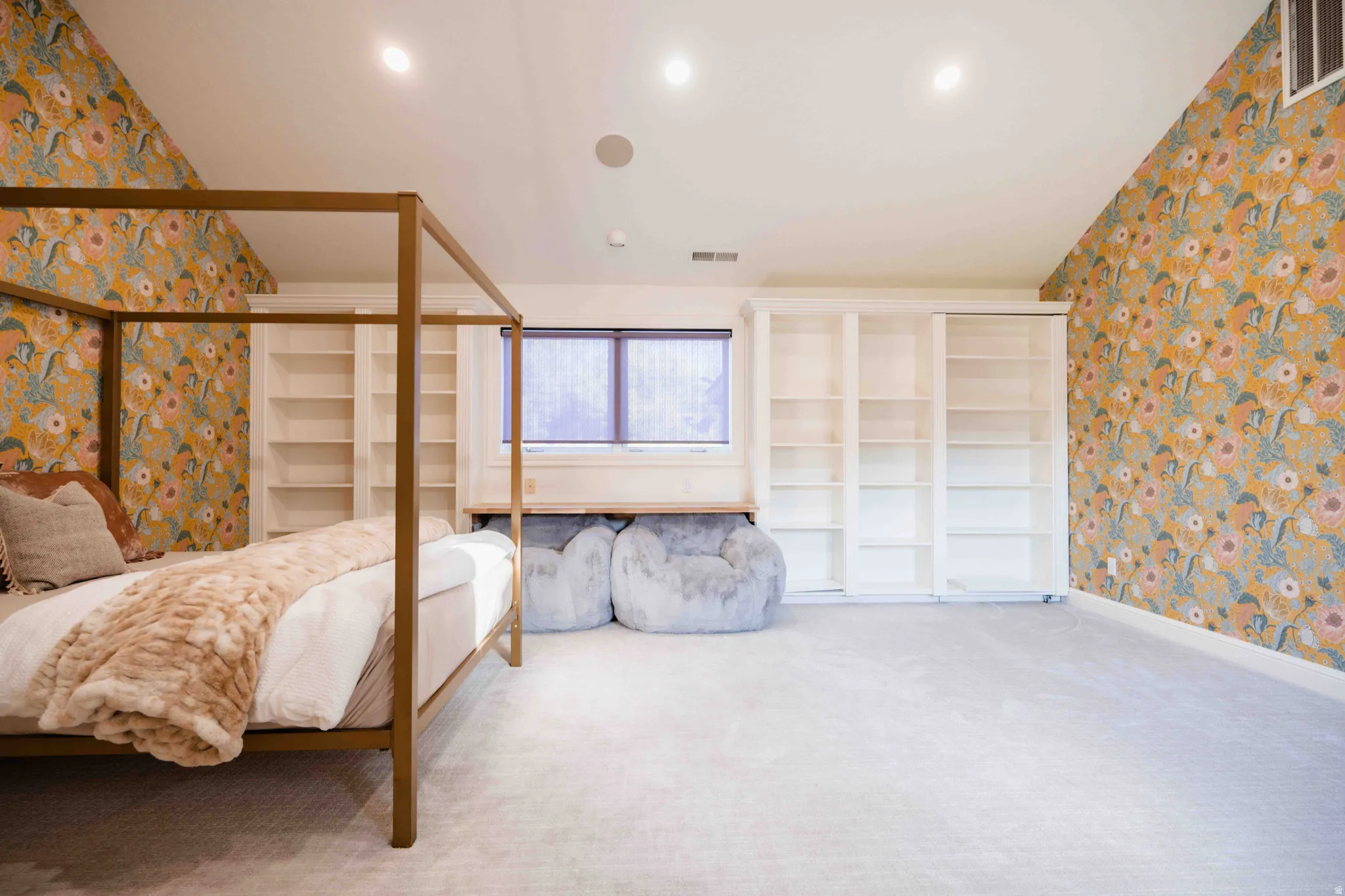 Built-in shelving, recessed lighting, wall-to-wall carpeting, and a window with a built-in desk area