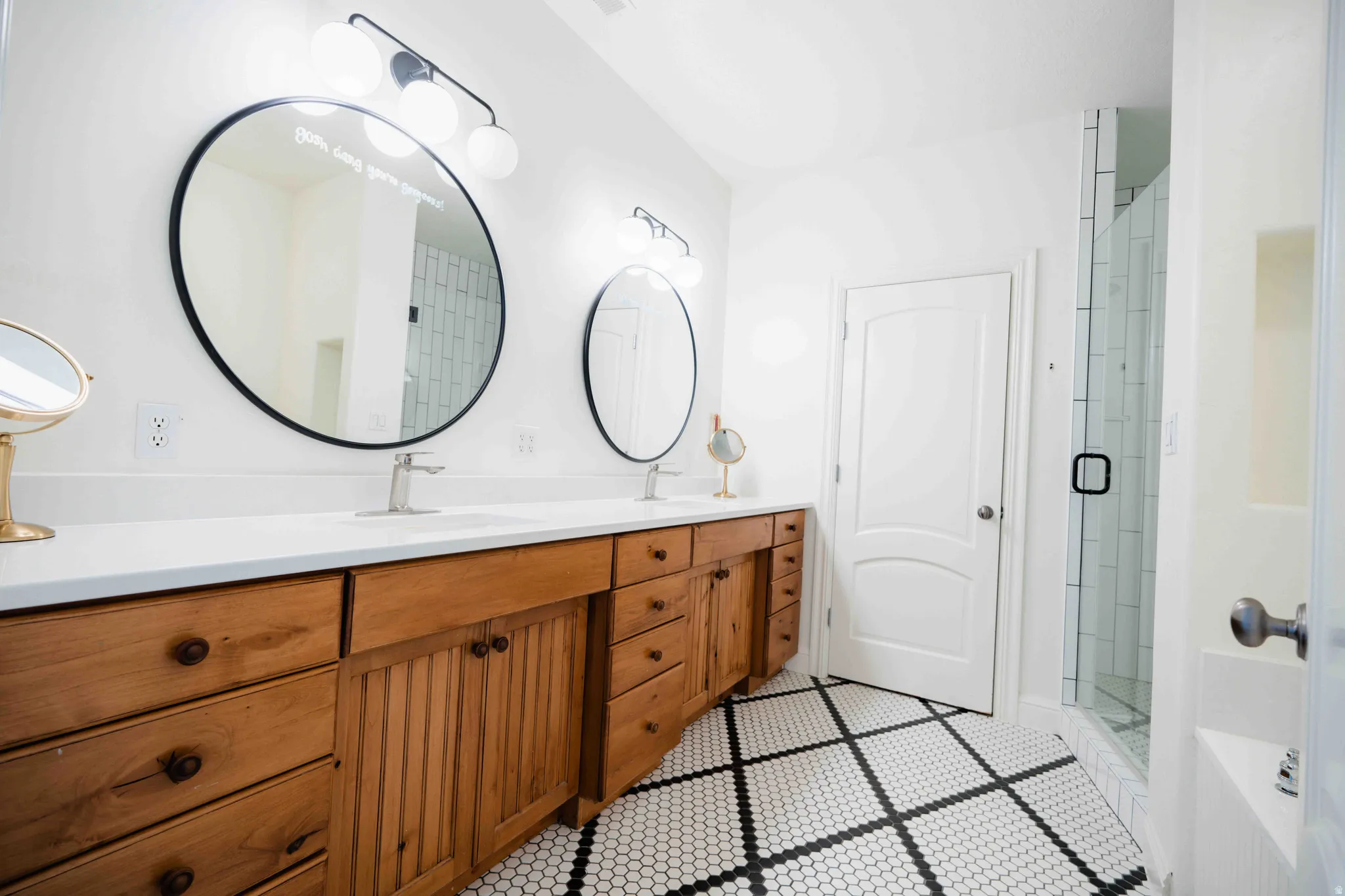 Dual vanity with wood cabinetry and undermount sinks