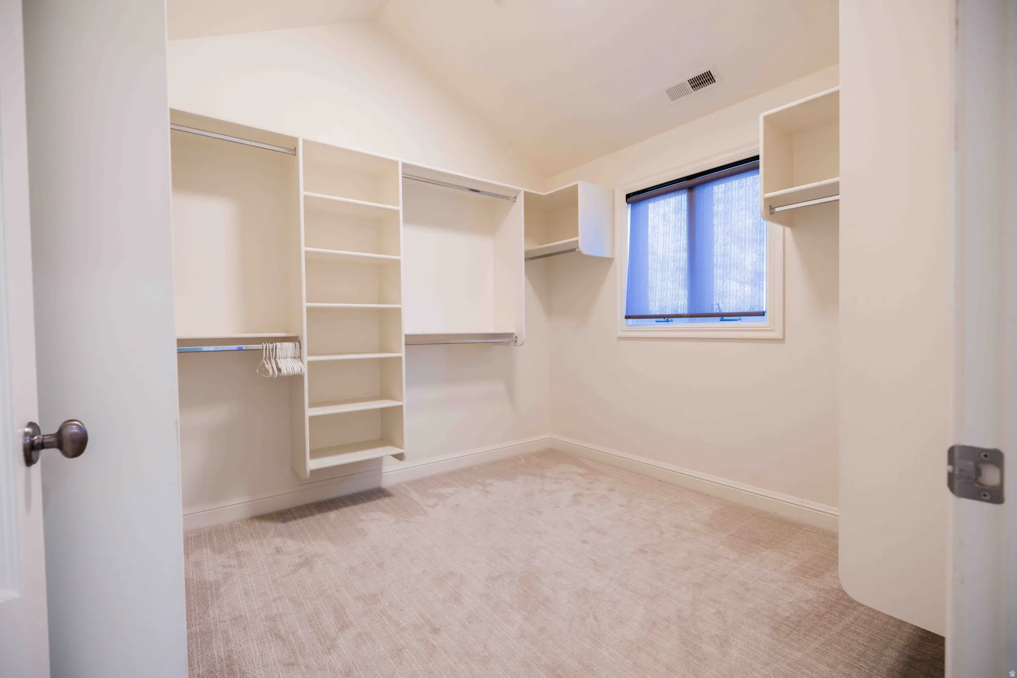 Custom closet organization system featuring shelving and hanging rods