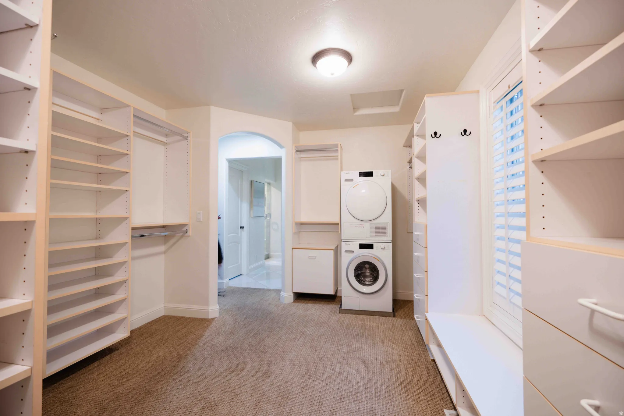 Custom closet system featuring extensive shelving and hanging rods