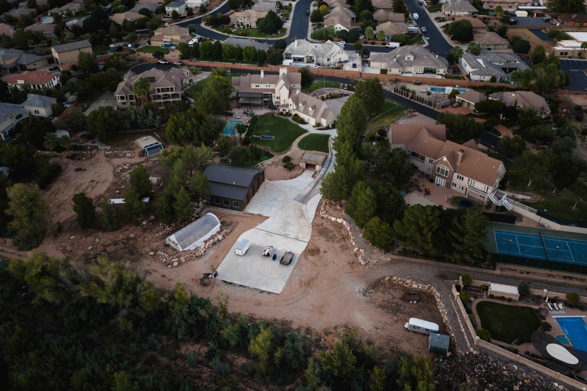 Expansive property featuring a swimming pool, and multiple detached structures