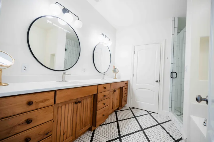 Dual vanity with wood cabinetry and undermount sinks