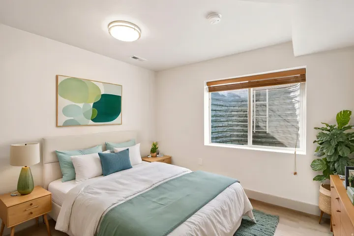 Recessed window with wood-finish blinds, light wood-finish flooring, and a neutral color palette