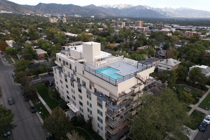 Rooftop swimming pool and lounge area with mountain scenery