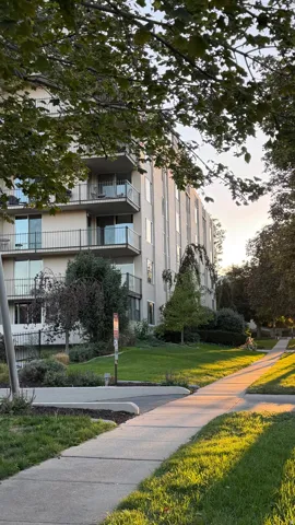 Multi-story building with multiple balconies featuring metal railings and glass panels