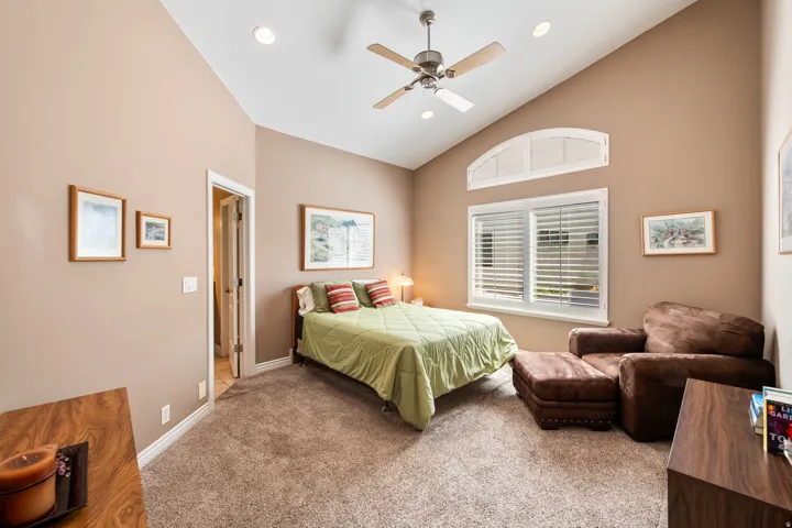 Vaulted ceiling with recessed lighting, ceiling fan, large window to allow plenty of light.