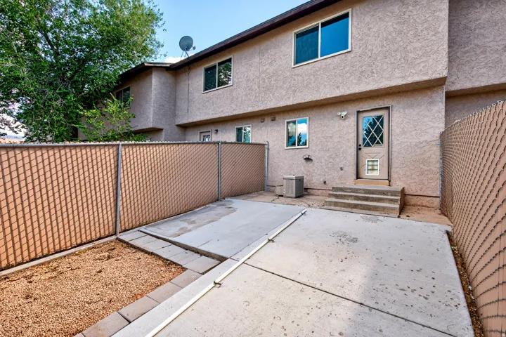 Private exterior patio with concrete surfacing and partial gravel landscaping