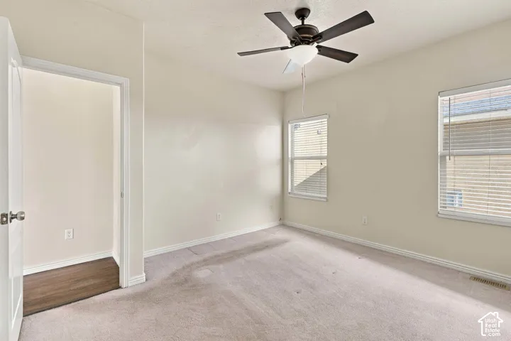 Recessed lighting, wood-finish flooring, two windows with blinds, ceiling fan with integrated light