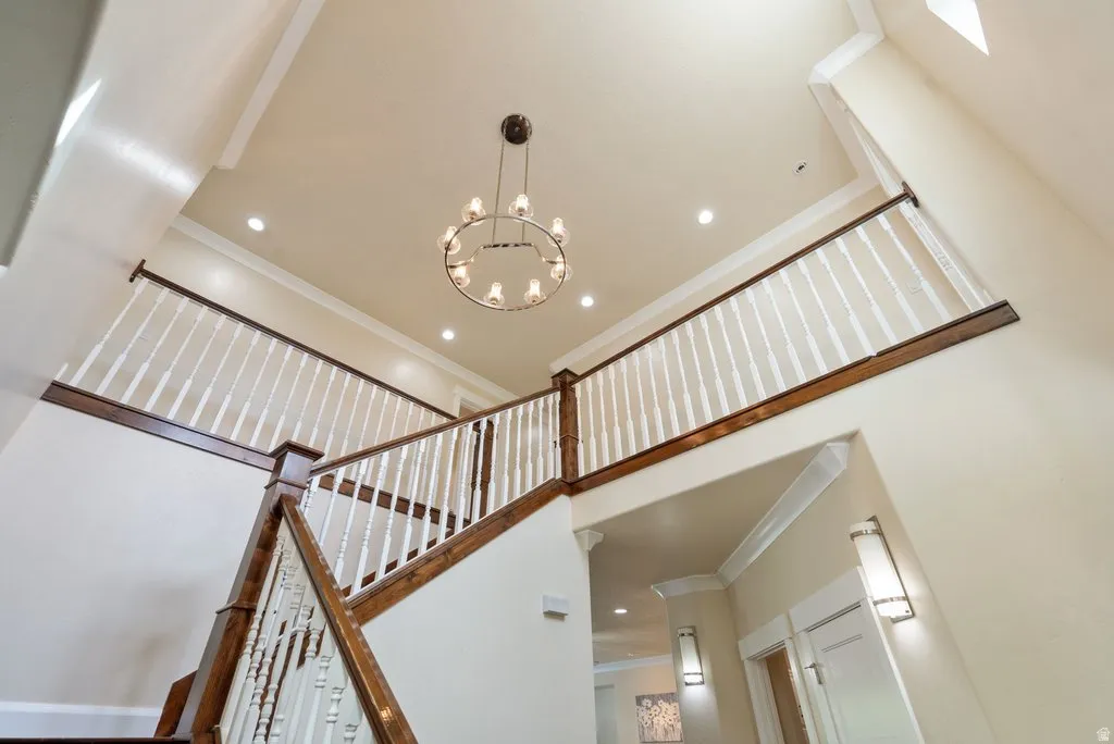 Two-story entry with hardwood stair treads, painted balusters, and a dark wood handrail