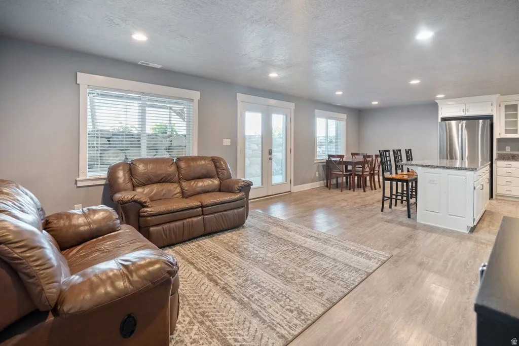 Open-concept living area with recessed lighting and wood-finish flooring