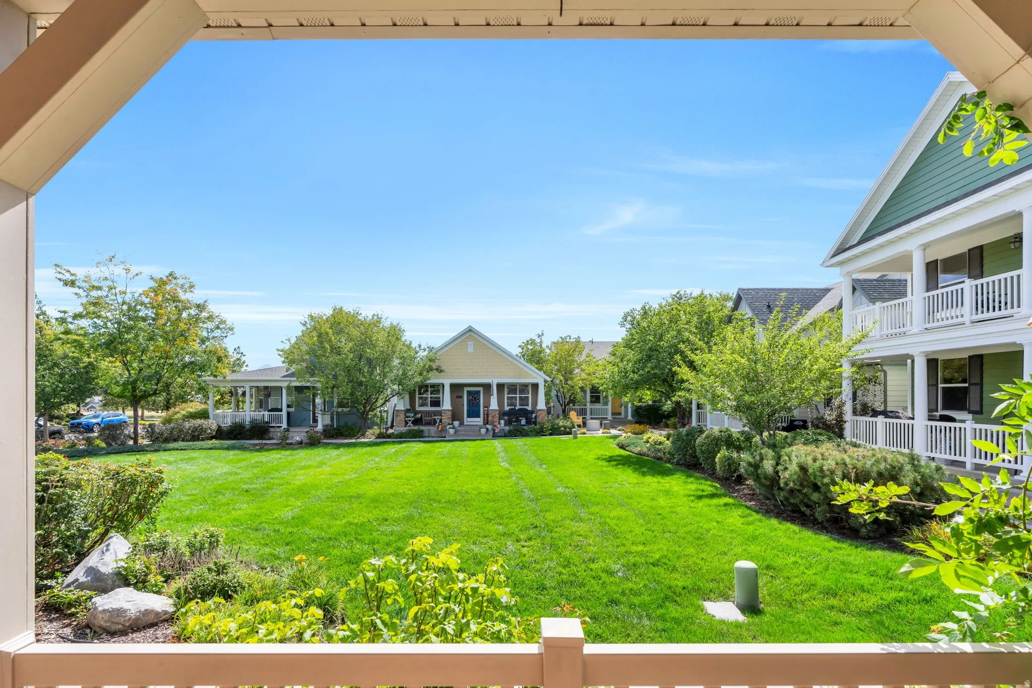 Expansive green space with mature trees and landscaped shrubbery