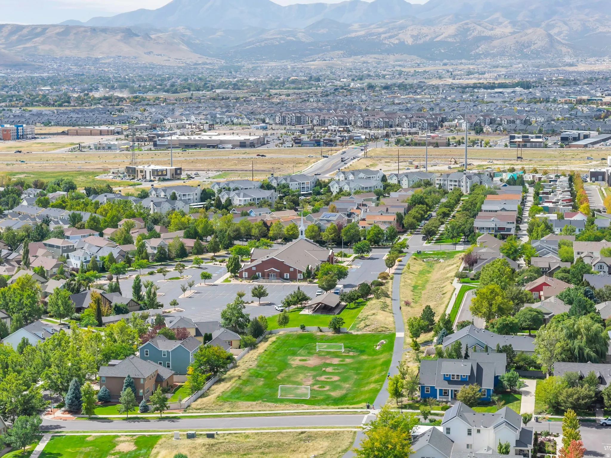 Residential community with established landscaping and mountain backdrop