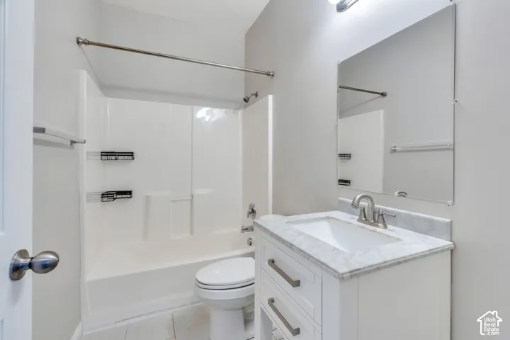 White vanity with a marble-finish countertop, undermount sink, and brushed nickel faucet