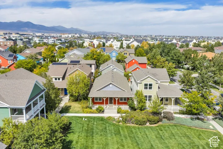 Expansive community with varied architectural styles, manicured green spaces, and mature landscaping
