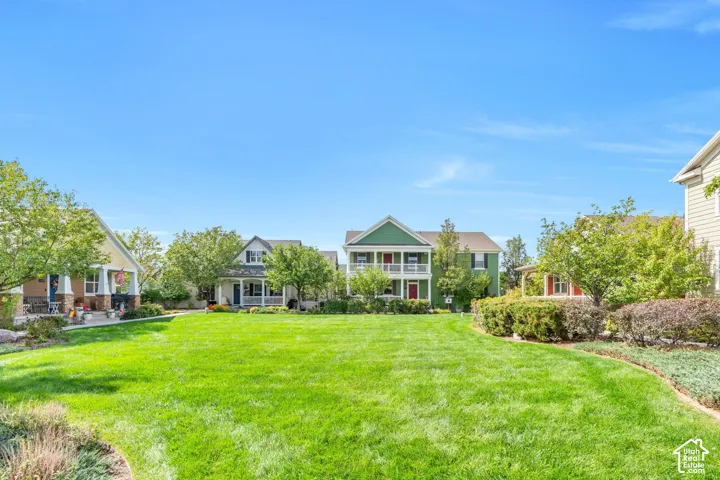 Expansive green space with manicured lawn and established landscaping