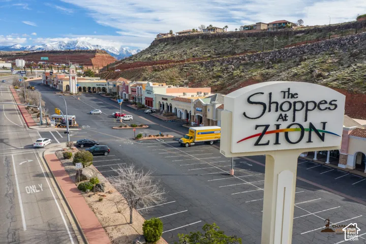 Retail center with extensive surface parking and a prominent business sign