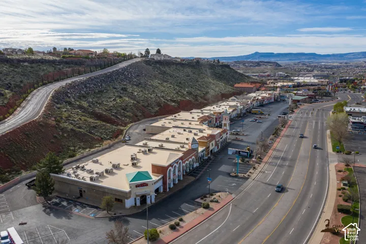 Commercial strip center with multiple retail units, ample paved parking, and direct main road frontage