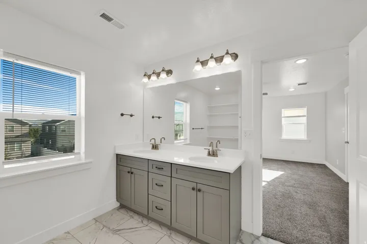 Dual vanity with gray cabinetry and white countertop