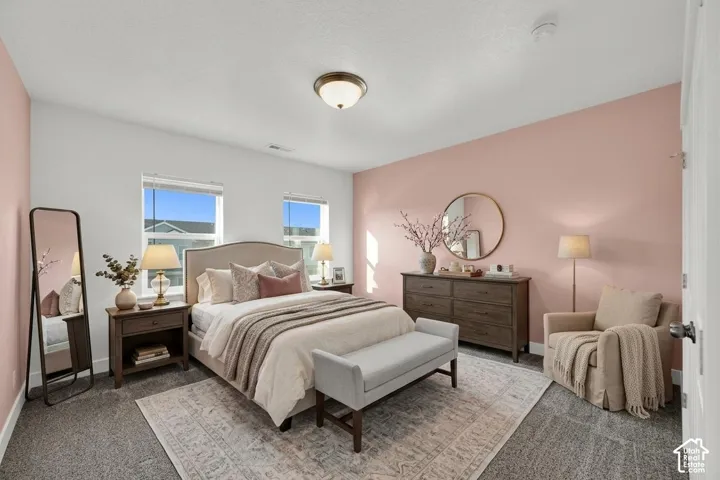 Wall-to-wall carpeting with a light-colored area rug