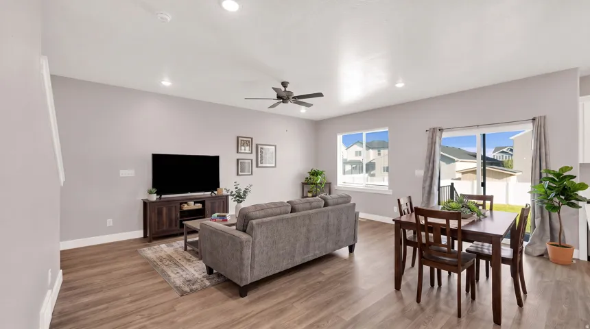 Open-concept living area featuring wood-finish flooring, recessed lighting, and a ceiling fan