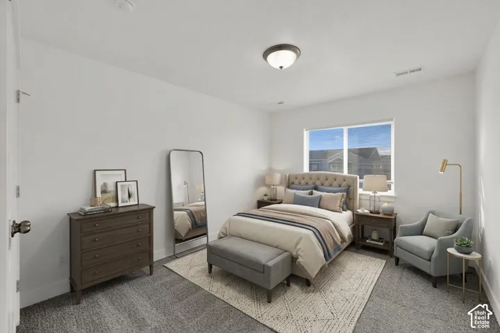 Neutral wall paint, carpeted flooring, window with blinds, and a ceiling-mounted light fixture