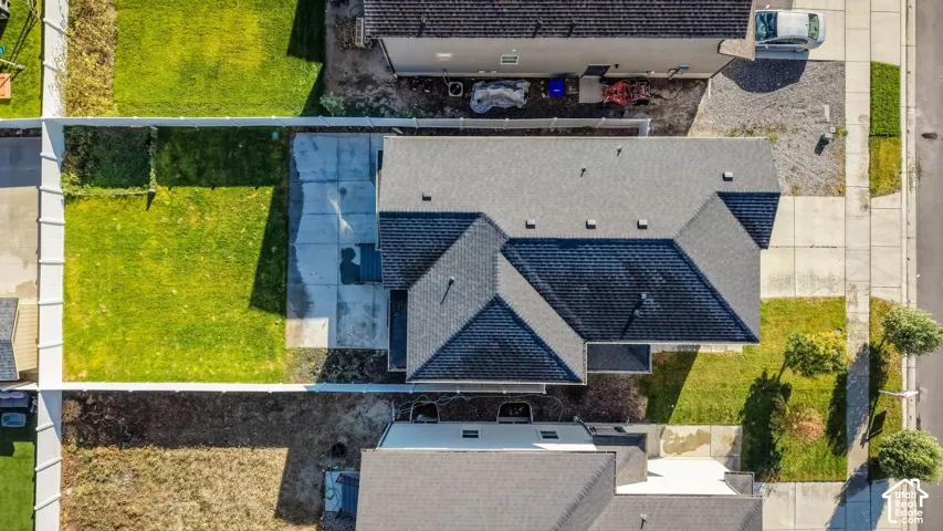 Expansive property featuring a gabled roofline, concrete driveway, and a large lawn area