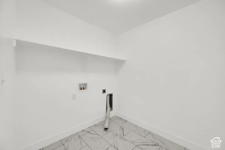 Laundry area with white walls and a built-in white shelf