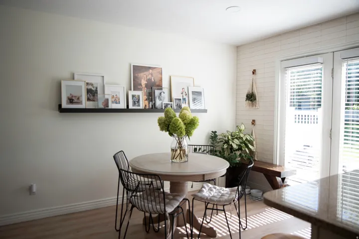 Recessed ceiling lighting, wood-finish flooring, built-in wooden bench, French doors, and a tiled wall