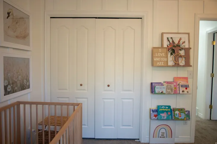 White bi-fold closet doors with round wooden knobs