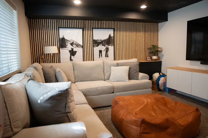 Recessed lighting illuminates the space, complemented by a wood-slat accent wall