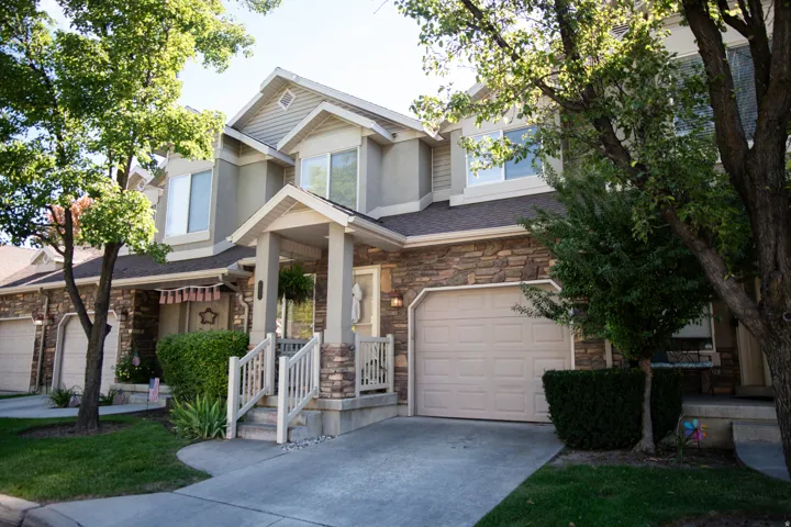 Multi-level exterior with stone veneer and stucco finishes