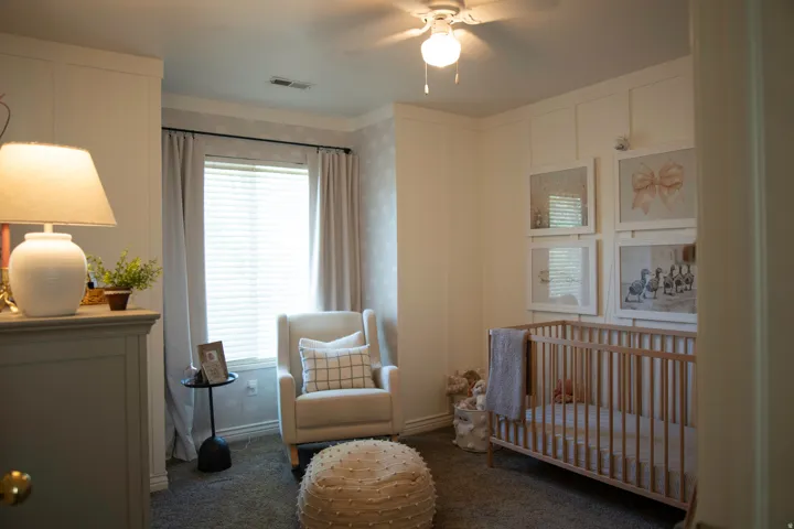 Board and batten wall detailing, window with blinds, ceiling fan, and carpeted flooring