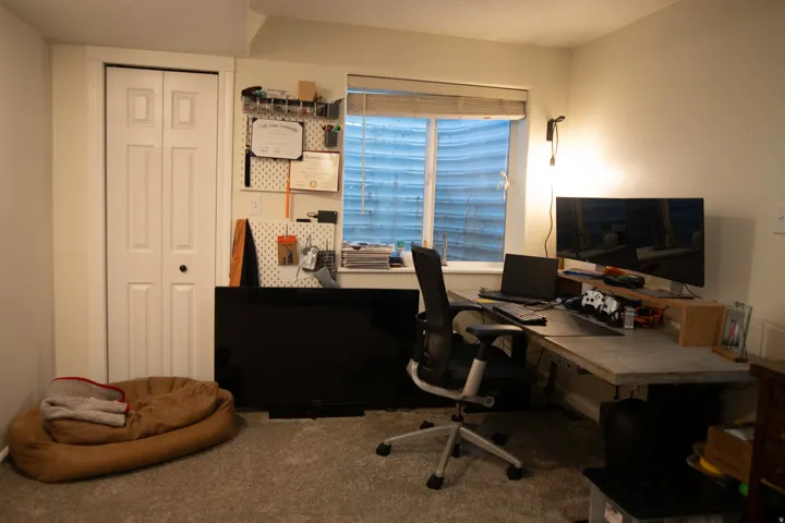 Carpeted flooring, bi-fold closet door, and a window with blinds