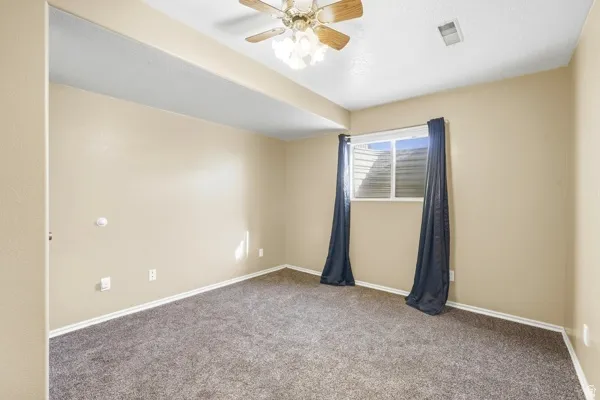 Neutral-toned walls complement the carpeted flooring