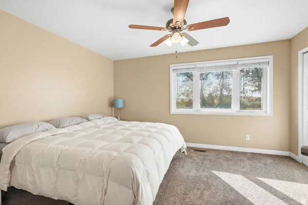 Neutral-toned walls complement the carpeted flooring