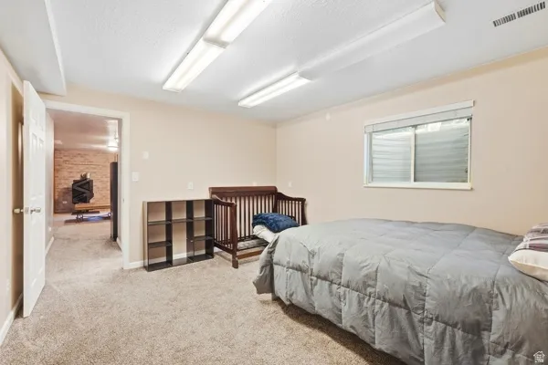 Neutral-toned walls complement the carpeted flooring