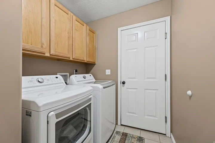 Built-in wood-finish cabinetry, tile flooring, and a six-panel interior door