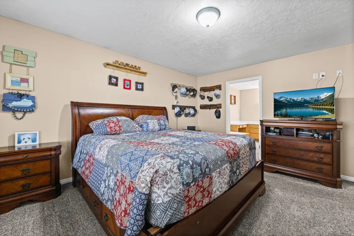 Carpeted flooring, neutral wall color, and a ceiling-mounted light fixture