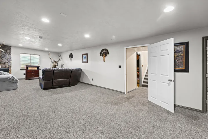 Recessed lighting illuminates the carpeted floor